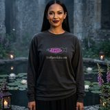Woman with long straight black hair wearing the Nightshade logo long sleeve tee in Black, by a moonlit lily pond in old abbey ruins