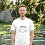 Man with red hair and a short beard wearing the I Came for One Fish tee in White, in a backyard with stock tank ponds of water lettuce and lilies