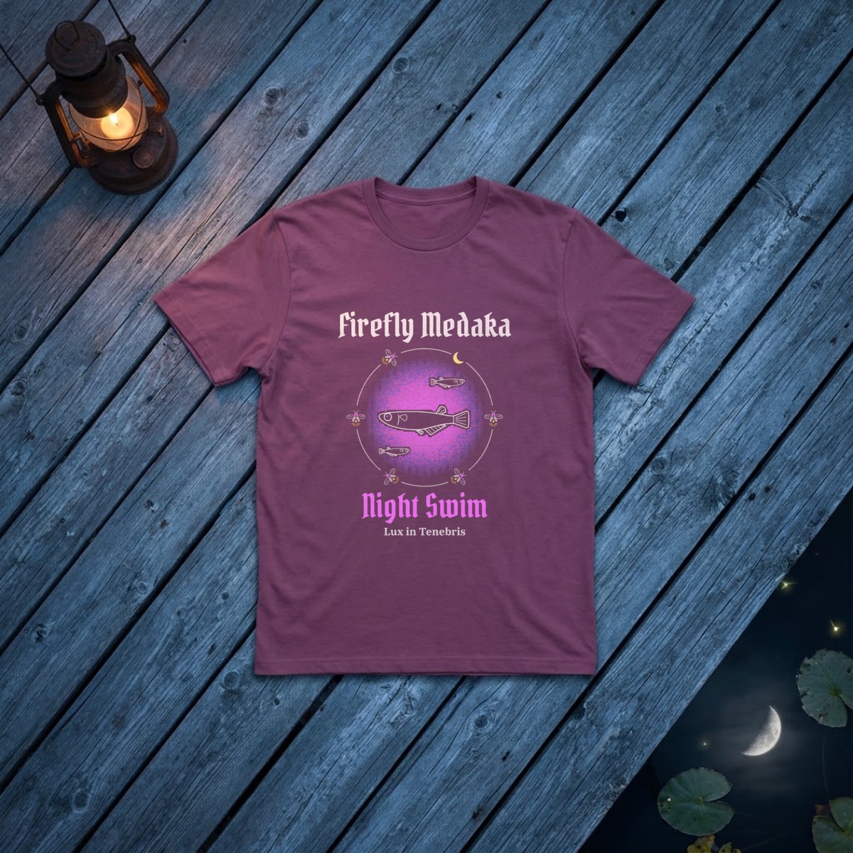 Night Swim medaka t-shirt in Berry on dark dock boards at the edge of a night pond with lily pads, firefly glows, a reflected crescent moon, and a candle lantern